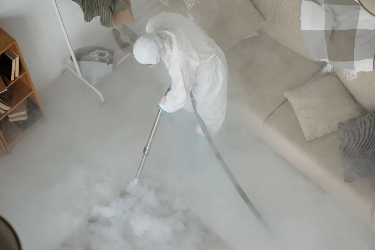 Biohazard cleanup technician in protective equipment, Oyster Creek, TX